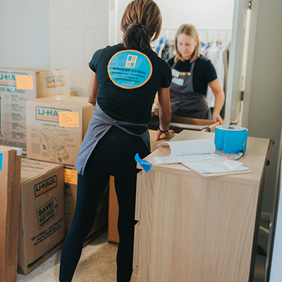 ladies organizing boxes